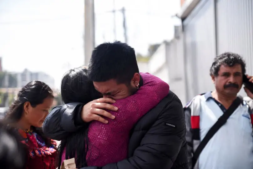 migrant is greeted by a family member outside the Returned Migrant Reception Center in Guatemala City, Guatemala, Jan. 27, after he and other Guatemalan migrants arrived at La Aurora Air Force Base on a deportation flight from the U.S.